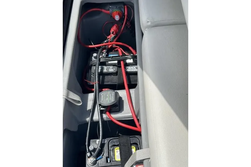 Slide: The Image of 2022 Starcraft SLS 3 boat battery compartment with wiring and connections. - 23