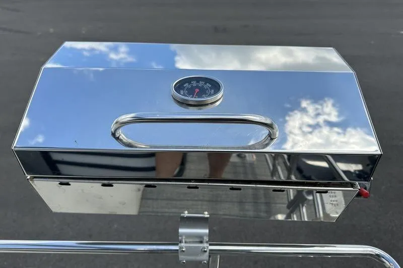 Slide: The Image of Shiny metal grill lid with thermometer, reflecting sky, Starcraft SLS 3, 2022 model. - 27