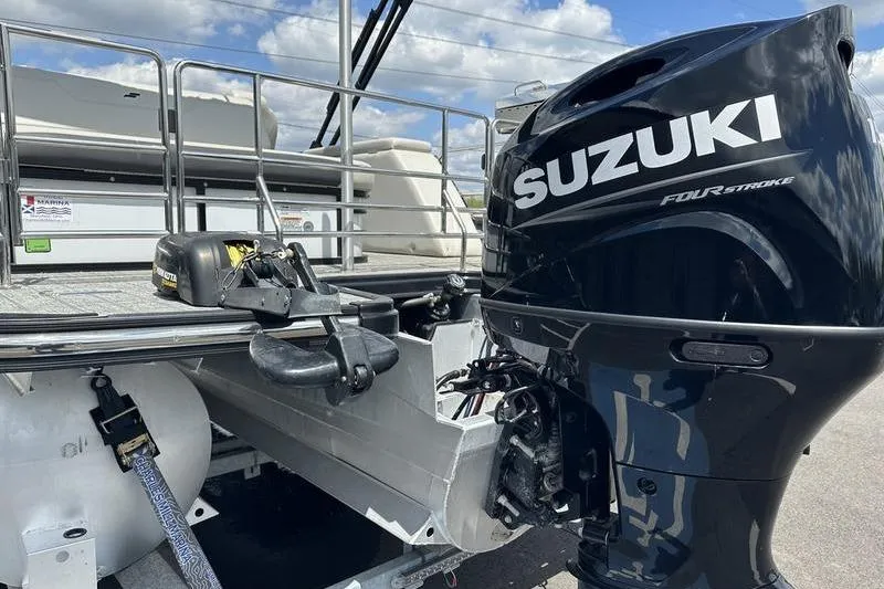 Slide: The Image of 2022 Starcraft SLS 3 boat with Suzuki four-stroke outboard motor, docked under a cloudy sky. - 7