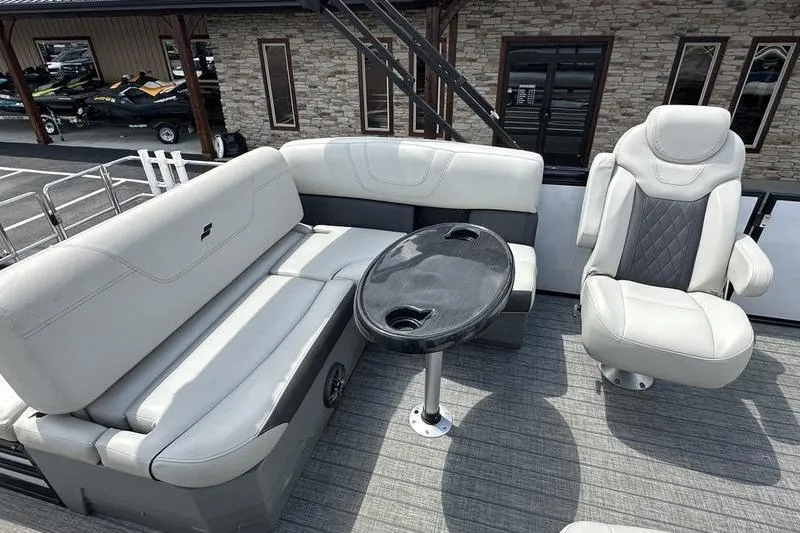 Slide: The Image of 2022 Starcraft SLS 3 boat interior with plush seating and a sleek table. - 8