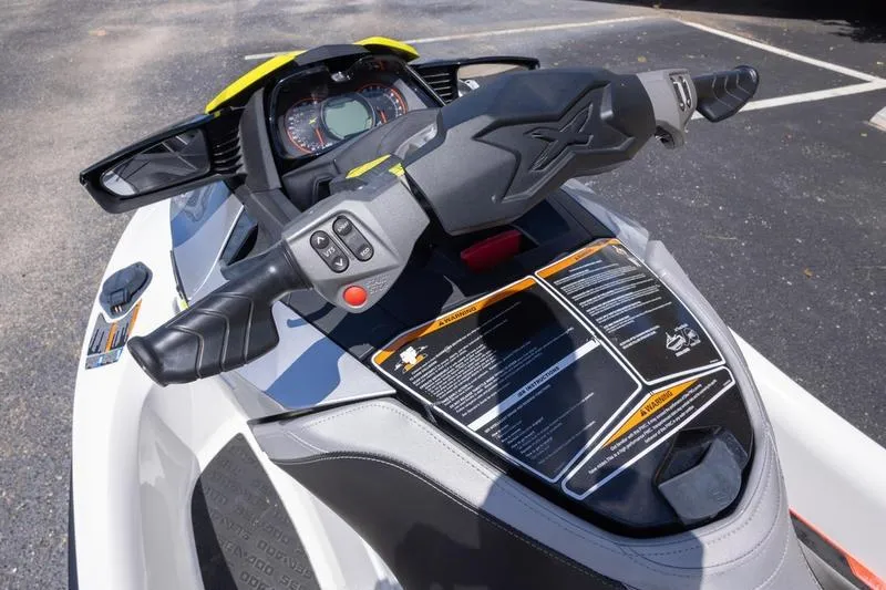 Slide: The Image of 2016 Sea Doo RXT 300 dashboard and controls, parked on asphalt. - 3