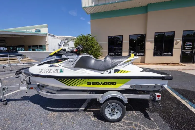 Slide: The Image of 2016 Sea Doo RXT 300 jet ski on trailer, parked outside a building. - 4