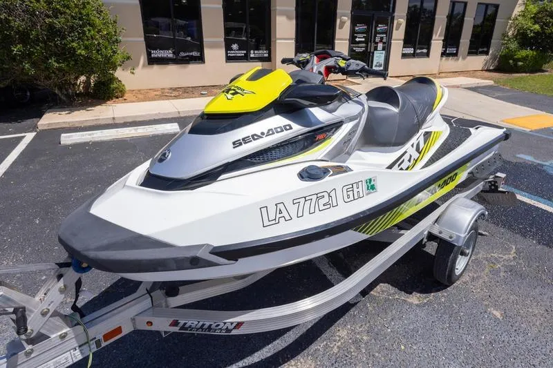 Slide: The Image of 2016 Sea Doo RXT 300 jet ski on trailer in parking lot. - 5