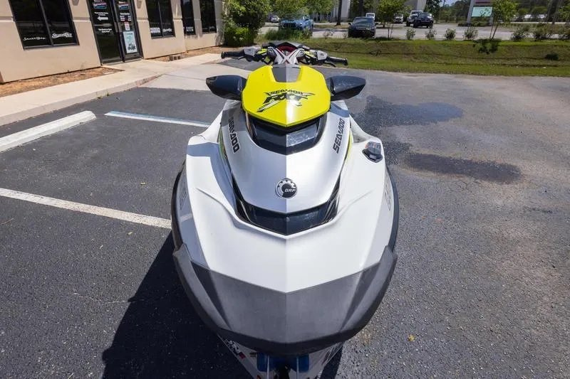 Slide: The Image of 2016 Sea Doo RXT 300 jet ski parked on asphalt near a building. - 8