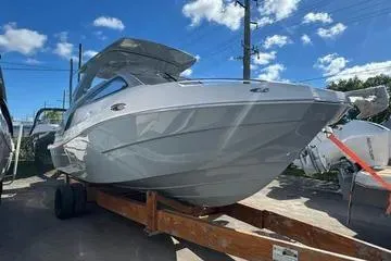 The Image of 2025 NX Boats NX280 XTREME on trailer under blue sky. - 1