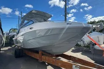 Slide: The Image of 2025 NX Boats NX280 XTREME on trailer under blue sky. - 3