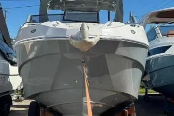 Slide: The Image of 2025 NX Boats NX280 XTREME, sleek design, docked, front view. - 8
