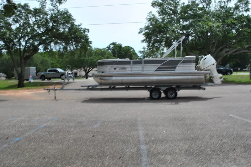 The Image of 2018 Trifecta 2.75 pontoon boat on trailer in parking lot. - 1