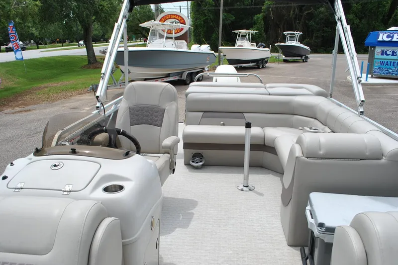 Slide: The Image of Interior of a 2018 Trifecta 2.75 pontoon boat with plush seating and steering console. - 16