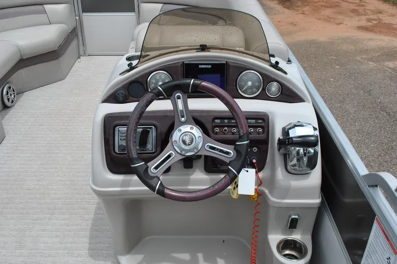 Slide: The Image of Steering console of 2018 Trifecta 2.75 pontoon boat with controls and gauges. - 17