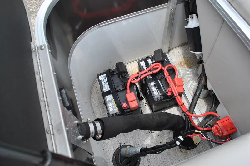 Slide: The Image of 2018 Trifecta 2.75 boat battery compartment with wiring and dual batteries. - 25