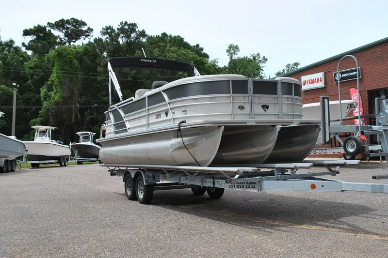 Slide: The Image of 2018 Trifecta 2.75 pontoon boat on trailer at dealership. - 5