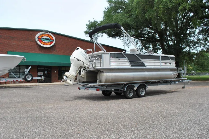 Slide: The Image of 2018 Trifecta 2.75 pontoon boat on trailer outside Sportsman's Marine store. - 7