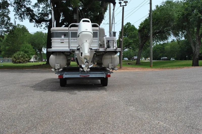 Slide: The Image of 2018 Trifecta 2.75 pontoon boat on trailer in a park setting. - 8