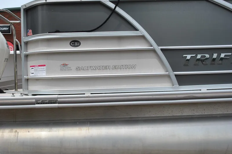 Slide: The Image of 2018 Trifecta 2.75 Saltwater Edition pontoon boat side view. - 9