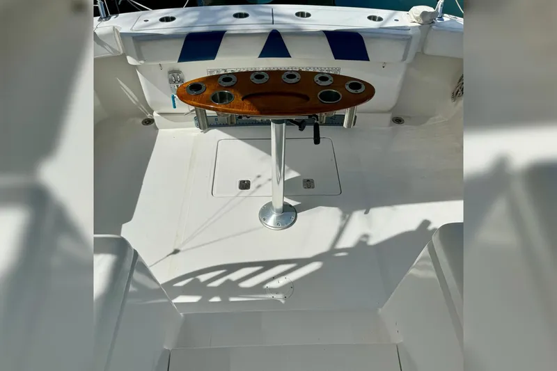 Slide: The Image of 2006 Luhrs 28 Open boat deck with fishing rod holders and wooden table. - 12