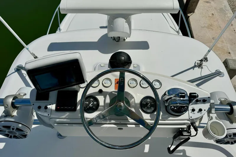 Slide: The Image of Helm of 2006 Luhrs 28 Open boat with steering wheel, gauges, and navigation equipment. - 13