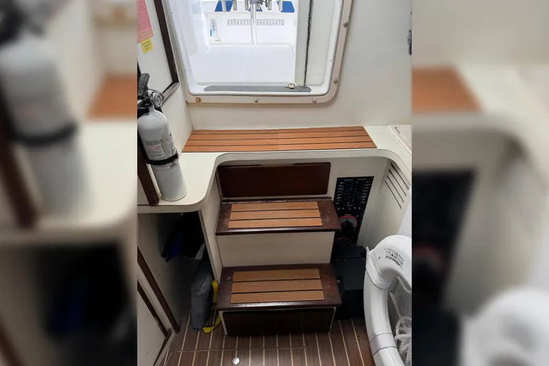 Slide: The Image of 2006 Luhrs 28 Open boat interior with wooden steps and safety equipment. - 14