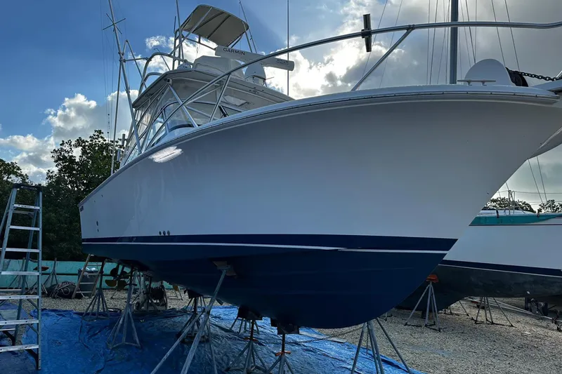 Slide: The Image of 2006 Luhrs 28 Open boat on stands, clear sky background. - 3