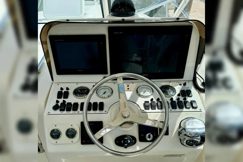 Slide: The Image of Control panel of a 2006 Luhrs 28 Open boat with steering wheel and gauges. - 8