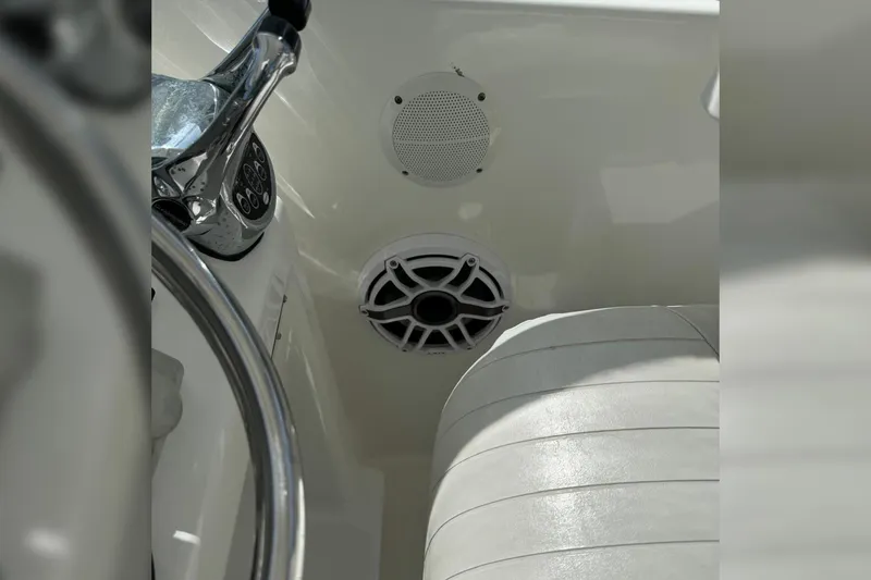 Slide: The Image of 2006 Luhrs 28 Open boat interior with steering wheel and speaker system. - 9