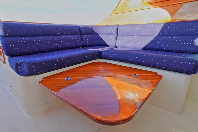 Slide: The Image of Luxurious seating area on a 2004 Hinckley Picnic Boat 36 EP with wooden table. - 10