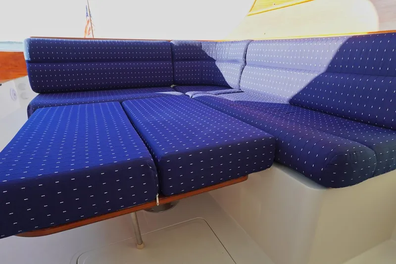 Slide: The Image of Blue cushioned seating on 2004 Hinckley Picnic Boat 36 EP, featuring a dotted pattern. - 11