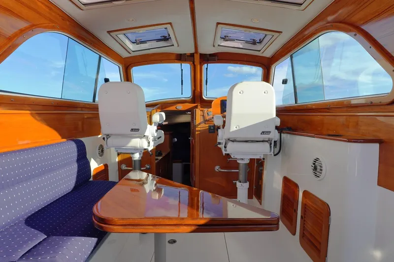 Slide: The Image of Interior of 2004 Hinckley Picnic Boat 36 EP with polished wood and seating. - 13