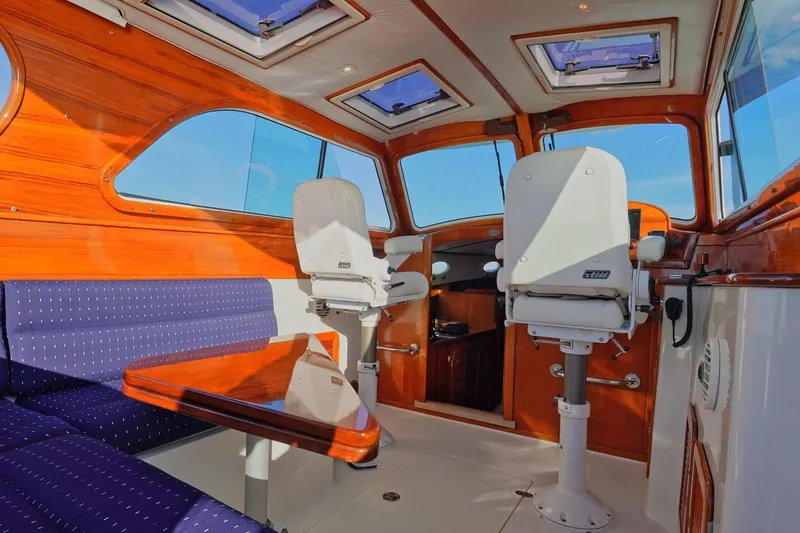 Slide: The Image of Interior of 2004 Hinckley Picnic Boat 36 EP with elegant wood finish and seating. - 14