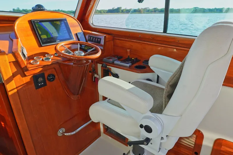 Slide: The Image of Helm of 2004 Hinckley Picnic Boat 36 EP with wooden dashboard and navigation screen. - 15