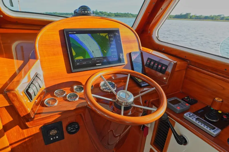 Slide: The Image of Helm of 2004 Hinckley Picnic Boat 36 EP with navigation equipment and wooden steering wheel. - 16