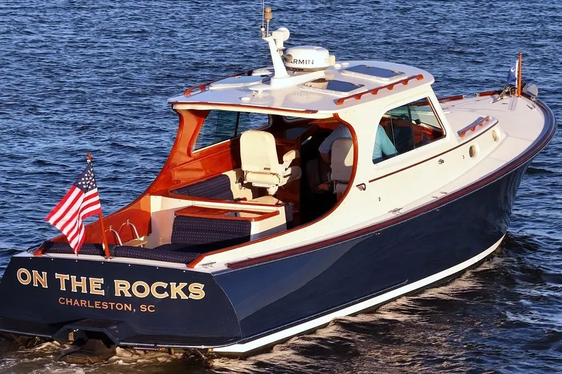 Slide: The Image of 2004 Hinckley Picnic Boat 36 EP cruising on water, named "On The Rocks," Charleston, SC. - 2