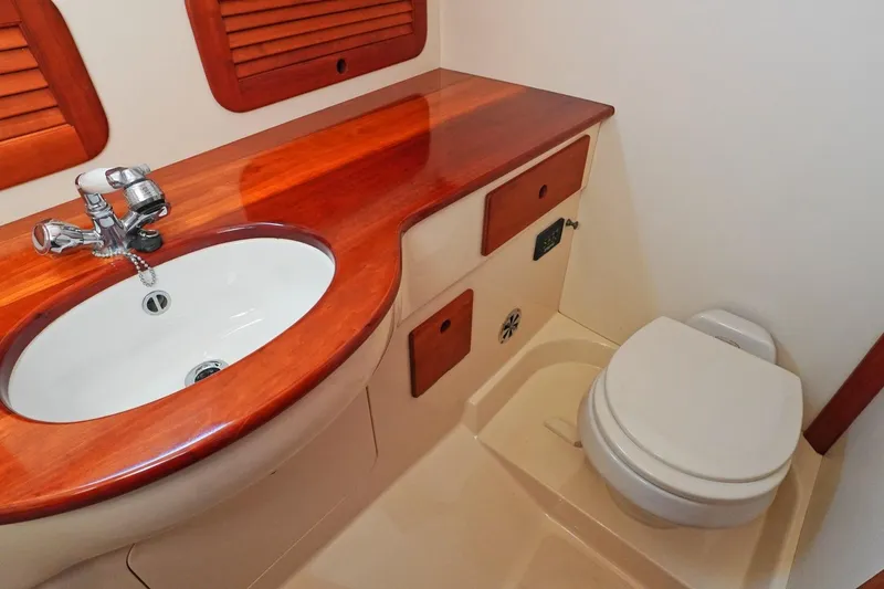 Slide: The Image of Luxurious bathroom in 2004 Hinckley Picnic Boat 36 EP with wooden accents and modern fixtures. - 23