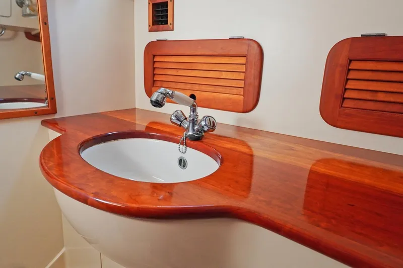 Slide: The Image of Luxurious wooden sink area in 2004 Hinckley Picnic Boat 36 EP. - 25