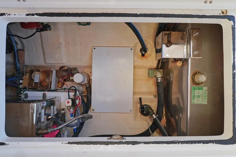 Slide: The Image of Engine compartment of a 2004 Hinckley Picnic Boat 36 EP, showcasing mechanical components. - 27