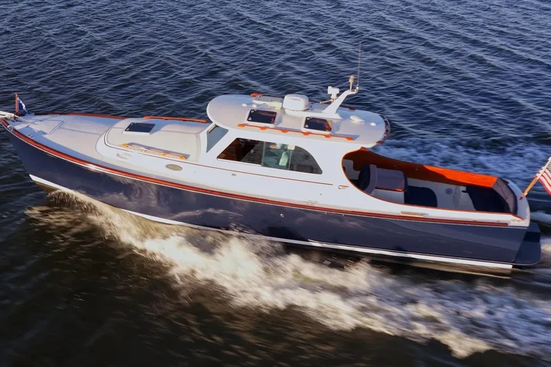 Slide: The Image of 2004 Hinckley Picnic Boat 36 EP cruising on water. - 4