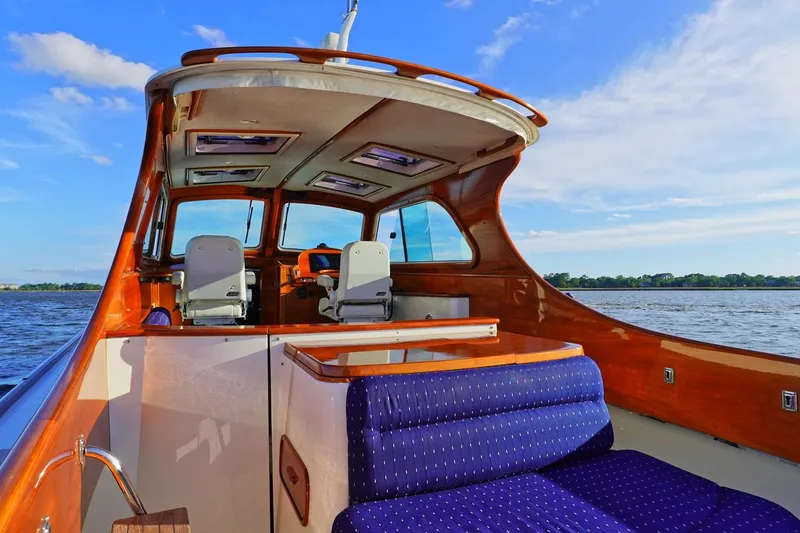 Slide: The Image of 2004 Hinckley Picnic Boat 36 EP interior with elegant seating and scenic water view. - 9