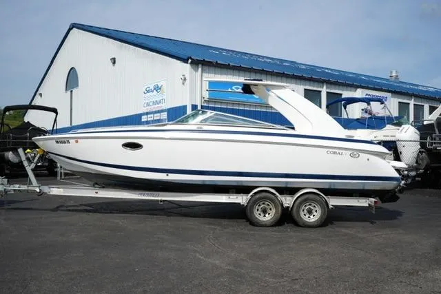 The Image of 2002 Cobalt 263 boat on trailer outside marine dealership. - 1