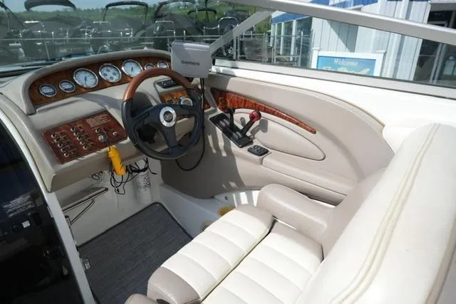 Slide: The Image of Cockpit of 2002 Cobalt 263 boat with steering wheel and control panel. - 11