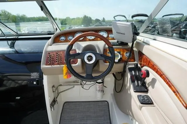 Slide: The Image of Steering console of a 2002 Cobalt 263 boat with Garmin navigation system. - 12