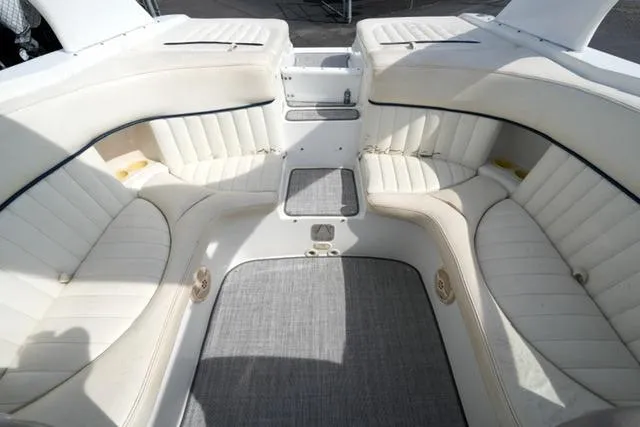 Slide: The Image of Interior of a 2002 Cobalt 263 boat with white cushioned seating and gray carpet. - 14