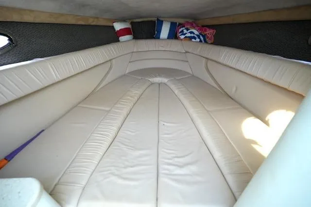 Slide: The Image of Interior cabin of a 2002 Cobalt 263 boat with beige seating and colorful pillows. - 16