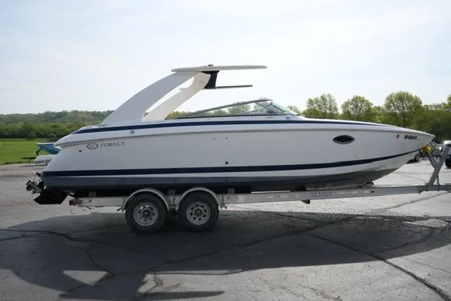 Slide: The Image of 2002 Cobalt 263 boat on trailer, parked outdoors, side view. - 4