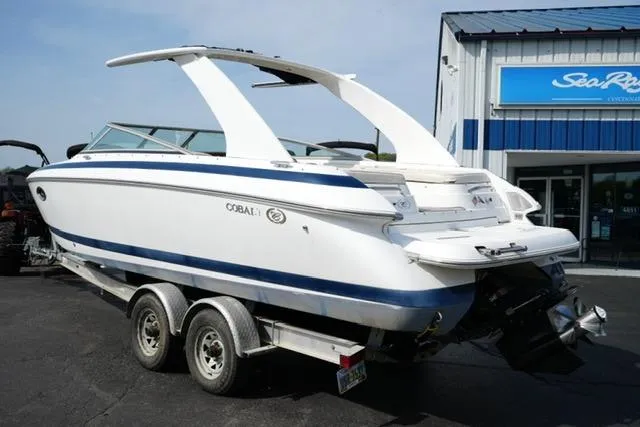 Slide: The Image of 2002 Cobalt 263 boat on trailer, parked outside a marine dealership. - 7