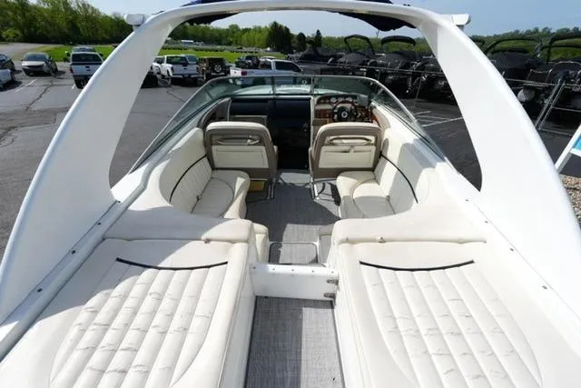 Slide: The Image of Interior view of a 2002 Cobalt 263 boat with white seating and dashboard. - 9