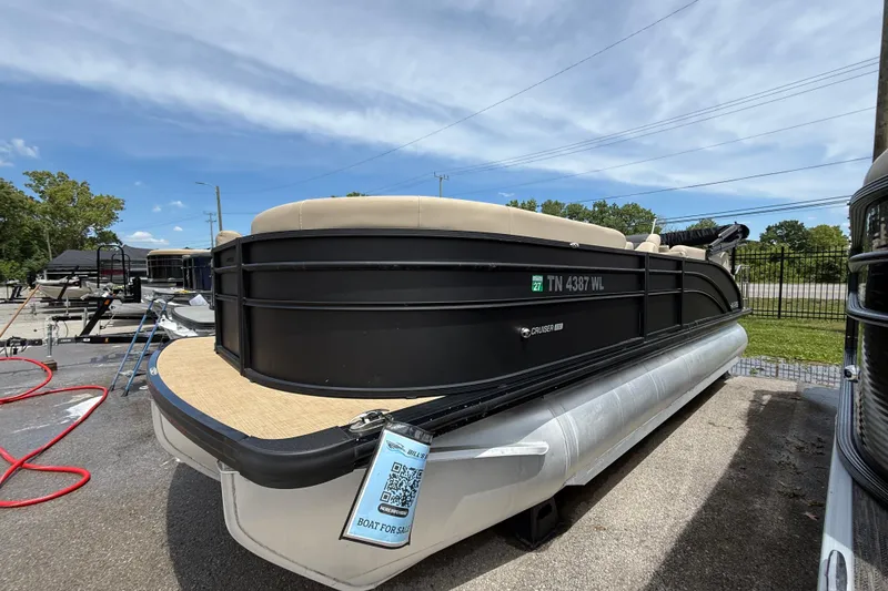 The Image of 2024 Harris Cruiser 230 pontoon boat on display in a sunny outdoor setting. - 0