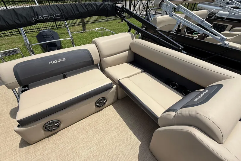 Slide: The Image of 2024 Harris Cruiser 230 boat interior with beige seating and cup holders. - 10