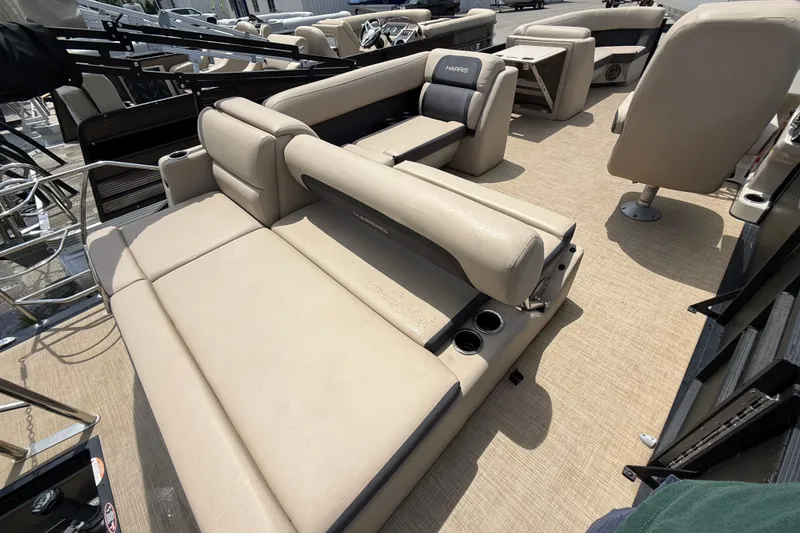 Slide: The Image of 2024 Harris Cruiser 230 boat interior with beige seating and cup holders. - 11