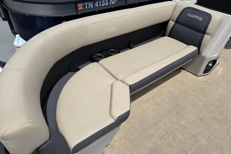 Slide: The Image of 2024 Harris Cruiser 230 boat interior with beige seating and cup holders. - 5