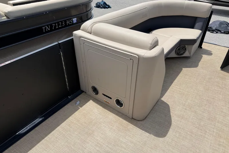 Slide: The Image of 2024 Harris Cruiser 230 boat interior with beige seating and speaker system. - 7